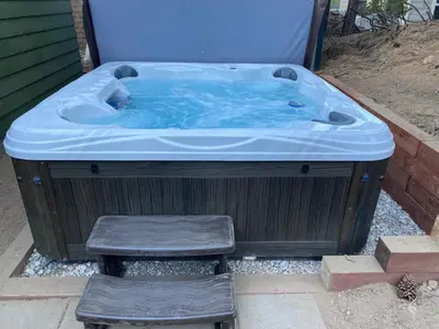 a hot tub with two stools in front of it at Village and Lake Escape - Walk to the Lake and Village in Big Bear Lake