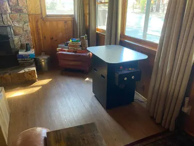 a room with a desk and a table in front of a window at Village and Lake Escape - Walk to the Lake and Village in Big Bear Lake