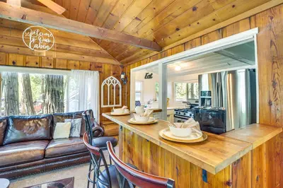 a kitchen and living room with a bar in a house at Pet-Friendly California Abode with Fenced-In Yard! in Crestline