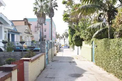 a street with palm trees and a fence at Villa by the Ocean in Venice Beach in Los Angeles