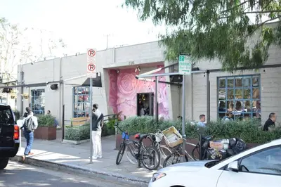 a man standing on a sidewalk in front of a store at Villa by the Ocean in Venice Beach in Los Angeles