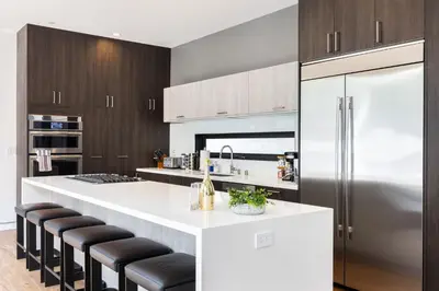 a kitchen with a white counter and a refrigerator at The Palms Pad - 5 Min from Beach - Golf,Arcade,Sauna in Los Angeles