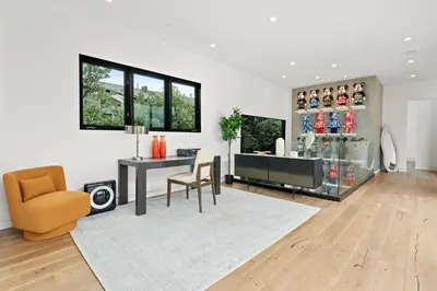 a living room with a desk and a chair at The Palms Pad - 5 Min from Beach - Golf,Arcade,Sauna in Los Angeles