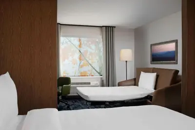a hotel room with two beds and a window at Fairfield by Marriott Inn & Suites Chino in Chino