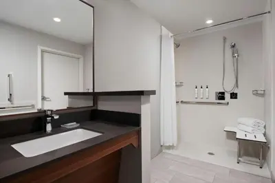 a bathroom with a sink and a shower at Fairfield by Marriott Inn & Suites Chino in Chino
