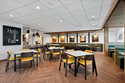 a restaurant with tables and chairs and a bar at Fairfield by Marriott Inn & Suites Chino in Chino