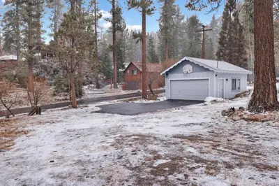 a garage in the middle of a snow covered yard at Pinglewood Cabin- Furnished Fawnskin Group Retreat in Fawnskin