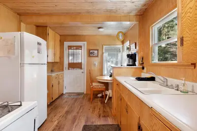 a kitchen with a white refrigerator and a sink at Pinglewood Cabin- Furnished Fawnskin Group Retreat in Fawnskin