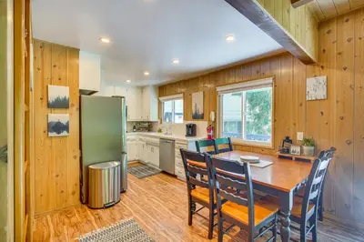 a kitchen with a table and a green refrigerator at Steps to Lake Arrowhead Cabin with Full Lake Access in Lake Arrowhead
