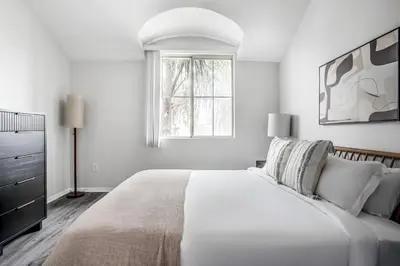 a white bedroom with a large bed and a window at West LA 2br w rooftop courtyard LAX-1055 in Los Angeles