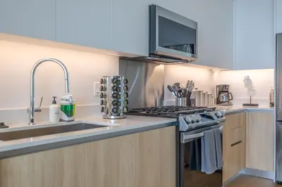 a kitchen with a sink and a stove at @ Marbella Lane - Sleek Corner Ocean View in Long Beach