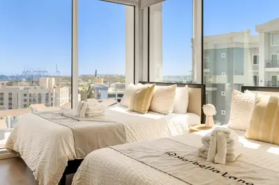 two beds in a room with a large window at #Marbella Lane - Panoramic Delight Dream Escape! in Long Beach