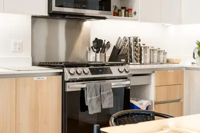 a kitchen with a stove top oven next to a counter at #Marbella Lane - Panoramic Delight Dream Escape! in Long Beach