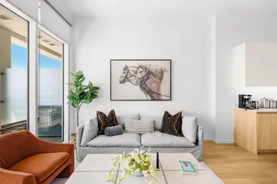 a living room with a couch and a horse picture on the wall at #Marbella Lane - Panoramic Splendid Ocean Views! in Long Beach