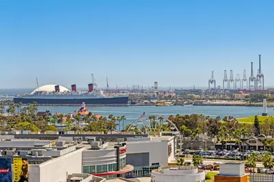 a cruise ship is docked at a harbor at #Marbella Lane - Panoramic Splendid Ocean Views! in Long Beach
