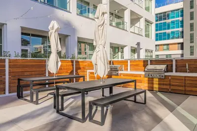 two picnic tables with umbrellas on a patio at #Marbella Lane - Panoramic Splendid Ocean Views! in Long Beach