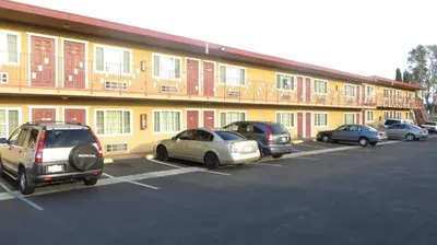 a group of cars parked in a parking lot in front of a building at Cloud 9 in Cypress