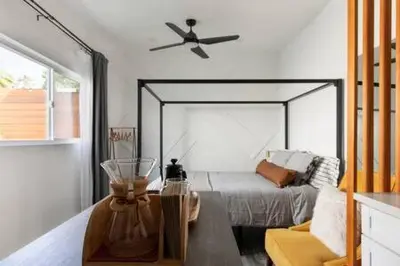 a bedroom with a bed with a ceiling fan at Vibe on the Patio at a Modern Luxury Studio near LAX Beach in Los Angeles