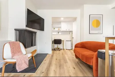 a living room with a couch and a television at Steps to Beach Manhattan Beach 2 Bedroom Parking in Manhattan Beach