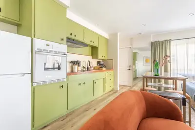 a kitchen with lime green cabinets and a table at Steps to Beach Manhattan Beach 2 Bedroom Parking in Manhattan Beach