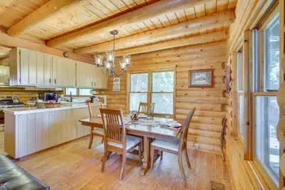 a dining room with a table and chairs in a cabin at Crestline Area Vacation Rental Cabin with Decks! in Crestline