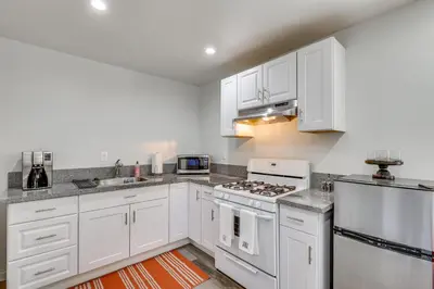 a kitchen with white cabinets and white appliances at Sleek San Fernando Studio about 14 Mi to Universal in San Fernando