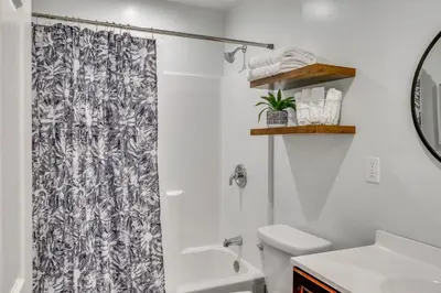 a bathroom with a shower curtain and a toilet at Sleek San Fernando Studio about 14 Mi to Universal in San Fernando