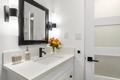a bathroom with a white sink and a mirror at Double King Suite with Patio Dining and Parking NRP21-00386 in Long Beach