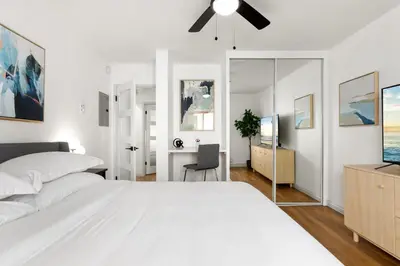 a white bedroom with a bed and a ceiling fan at Double King Suite with Patio Dining and Parking NRP21-00386 in Long Beach