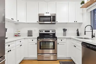a kitchen with white cabinets and a stainless steel oven at Double King Suite with Patio Dining and Parking NRP21-00386 in Long Beach