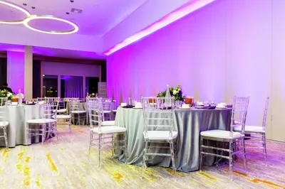 a room with tables and chairs and purple walls at Doubletree By Hilton Pomona in Pomona