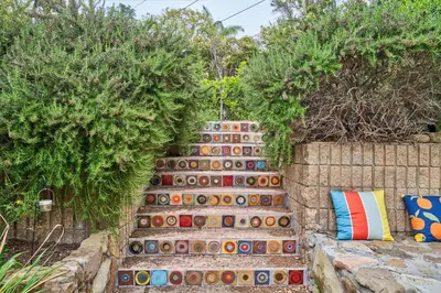 a garden with a retaining wall and colorful pillows at Ojai Vacation Home with Views on the East End in Ojai