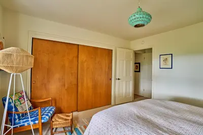 a bedroom with a bed and a wooden closet at Ojai Vacation Home with Views on the East End in Ojai