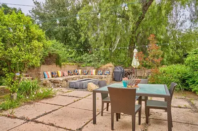 a patio with a table and chairs in a garden at Ojai Vacation Home with Views on the East End in Ojai