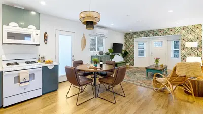 a kitchen and living room with a table and chairs at Urban Jungle by AvantStay in Los Angeles