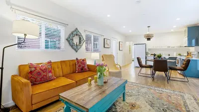 a living room with a couch and a table at Urban Jungle by AvantStay in Los Angeles