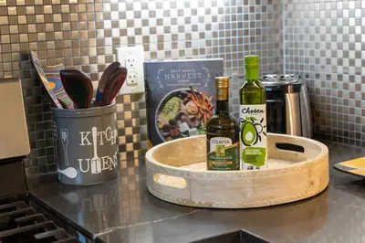 two bottles of wine in a wooden container on a kitchen counter at Villa La Verde - Newly Designed 4BR Villa with Pool & Guesthouse by Topanga in Los Angeles