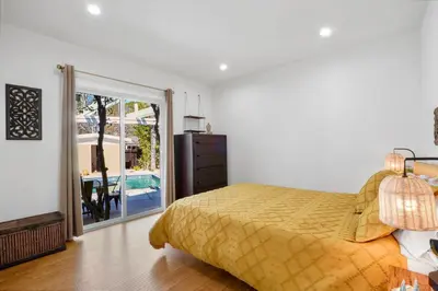 a bedroom with a bed and a door to a patio at Villa La Verde - Newly Designed 4BR Villa with Pool & Guesthouse by Topanga in Los Angeles
