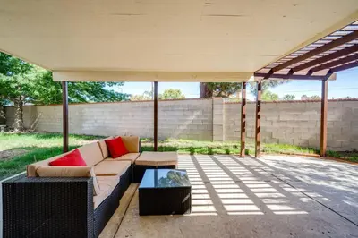 a patio with a couch and a coffee table at Families/Digital Nomads/Corporate Housing in Bakersfield