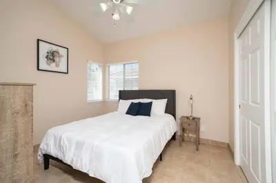 a bedroom with a white bed and a window at Families/Digital Nomads/Corporate Housing in Bakersfield