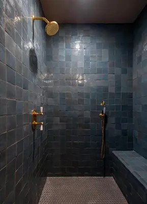 a blue tiled bathroom with a shower and a tub at Gjelina Hotel in Los Angeles
