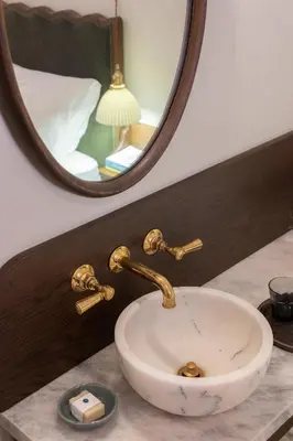 a white sink on a counter with a mirror at Gjelina Hotel in Los Angeles