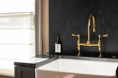 a bathroom sink with a bottle of wine next to it at Gjelina Hotel in Los Angeles
