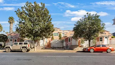a truck and a car parked in front of houses at Southwest by AvantStay in Los Angeles