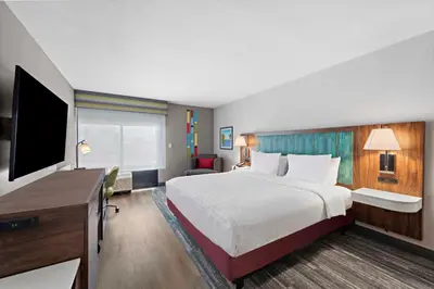 a hotel room with a large bed and a television at Hampton Inn Los Angeles Airport in Los Angeles