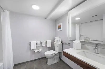 a white bathroom with a toilet and a sink at Hampton Inn Los Angeles Airport in Los Angeles