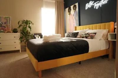 a bedroom with a bed with a wooden headboard at Lux Oasis in West Hollywood, Free Parking & Swimming pool in Los Angeles
