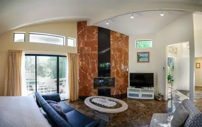 a living room with a blue couch and a tv at Large Luxury Studio with View in Santa Monica in Santa Monica