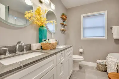a bathroom with a sink and a toilet and a mirror at Inglewood Vacation Rental 2 Mi to Sofi Stadium in Inglewood