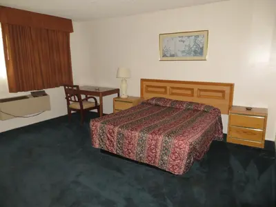 a hotel room with a bed and a desk at Jet Inn in Los Angeles